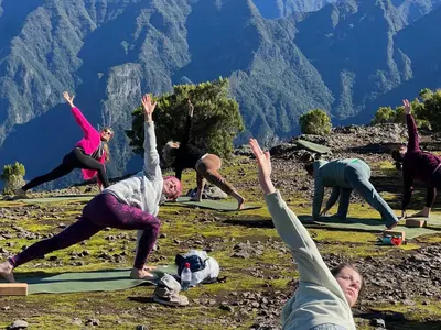 a group of people doing yoga on a mountain at Yeotown Madeira Wellness Hotel and Nature Stay in Arco da Calheta