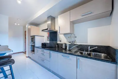 a kitchen with a sink and a counter top at Baía da Luz - Sea View Luxury Apartment in Luz