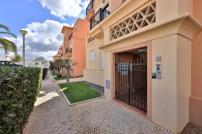 a building with a gate on a walkway at Baía da Luz - Sea View Luxury Apartment in Luz