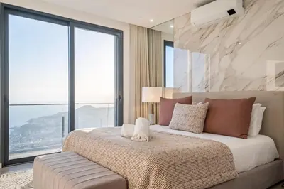 a bedroom with a large bed and large windows at Villa Boa Nova Preta by LovelyStay in Funchal