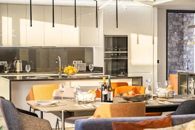 a kitchen with a table and chairs with wine glasses at Villa Boa Nova Preta by LovelyStay in Funchal