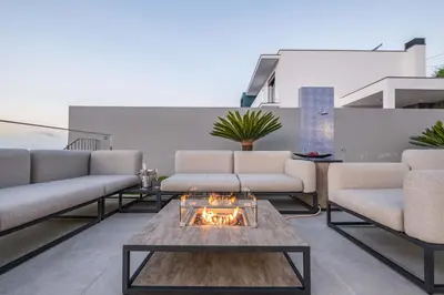 a patio with couches and a fire pit at Villa Boa Nova Preta by LovelyStay in Funchal