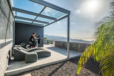 a man on a scooter on the balcony of a house at Villa Boa Nova Preta by LovelyStay in Funchal