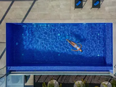 a person swimming in a pool in the water at Villa Boa Nova Verde by LovelyStay in Funchal