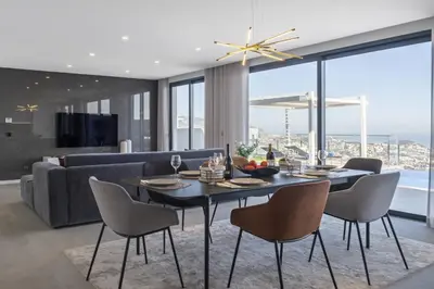 a dining room with a table and chairs and a couch at Villa Boa Nova Verde by LovelyStay in Funchal