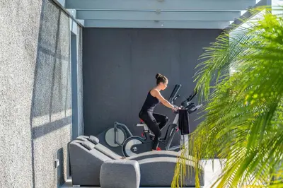 a woman riding an exercise bike on a treadmill at Villa Boa Nova Verde by LovelyStay in Funchal