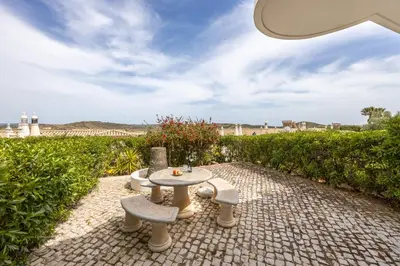 a patio with a table and two chairs and a table at Townhouse da Amarela in Budens