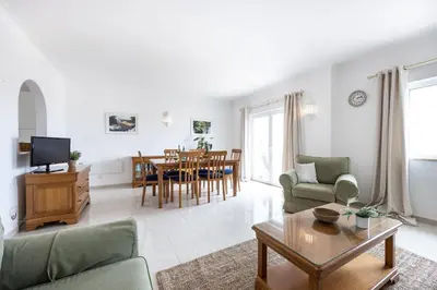 a living room with a couch and a table at Townhouse da Amarela in Budens