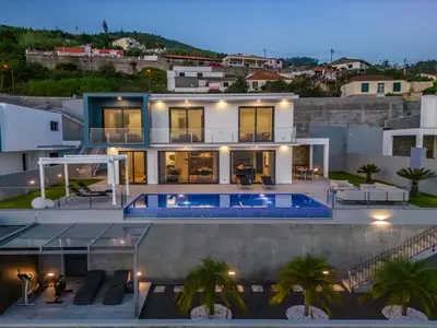 a villa with a swimming pool at night at Villa Boa Nova Branca by LovelyStay in Funchal