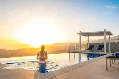 a woman sitting in a pool on top of a house at Villa Boa Nova Branca by LovelyStay in Funchal