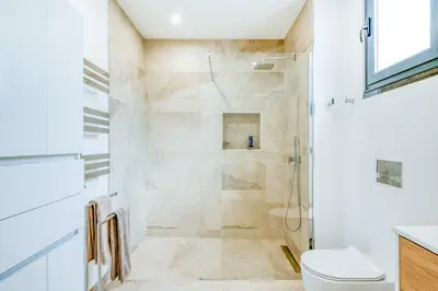 a bathroom with a shower and a toilet at Villa Boa Nova Branca by LovelyStay in Funchal