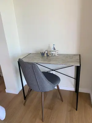 a desk with a chair in a room at Madeira Sea Sunshine with heated pool in Ribeira Brava