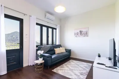 a living room with a couch and a television at Villa Pearl in Santana