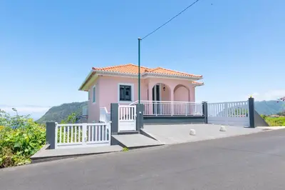 a small pink house on the side of a road at Villa Pearl in Santana