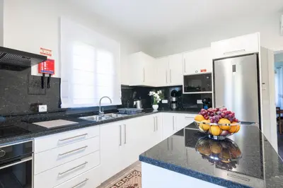 a kitchen with a bowl of fruit on a counter at Villa Pearl in Santana