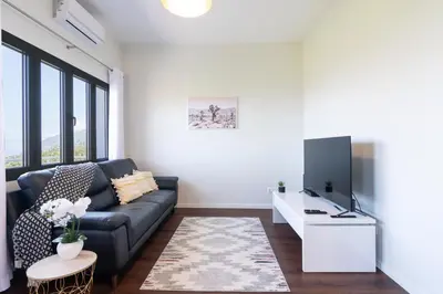 a living room with a couch and a tv at Villa Pearl in Santana