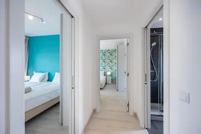a bedroom with a bed and a blue wall at Villa Sagres Surf in Sagres