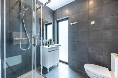 a bathroom with a shower and a toilet and a sink at Villa Sagres Surf in Sagres