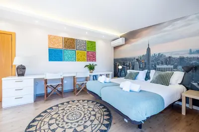 a bedroom with two beds and a desk at Villa Cercado, private swimming pool in Sagres