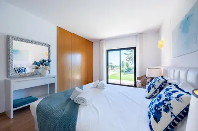 a bedroom with a bed with towels on it at Villa Cercado, private swimming pool in Sagres