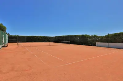 a tennis court with a net on top of it at Villa Cercado, private swimming pool in Sagres