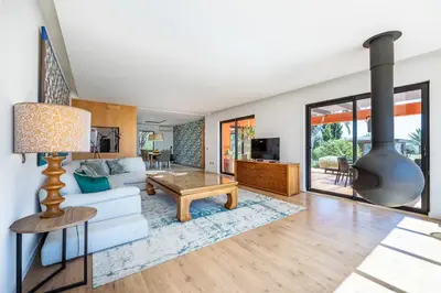a living room with a couch and a fireplace at Villa Cercado, private swimming pool in Sagres