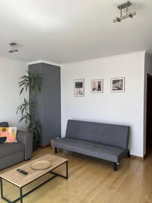 a living room with a couch and a coffee table at Central Park Sea Views in Santa Cruz