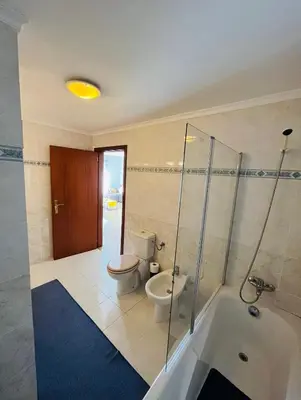 a bathroom with a tub and a toilet and a shower at Central Park Sea Views in Santa Cruz
