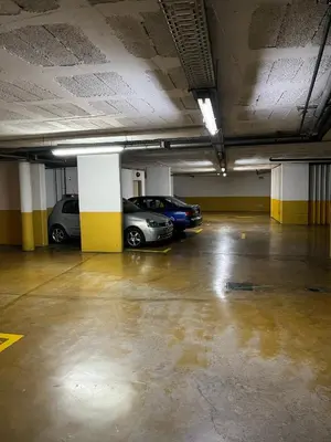 two cars parked in an empty parking garage at Central Park Sea Views in Santa Cruz
