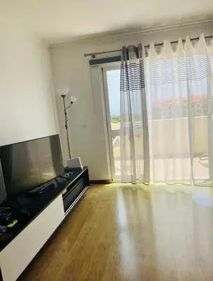 a living room with a television and a large window at Central Park Sea Views in Santa Cruz