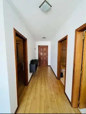 an empty hallway with two doors and a wooden floor at Central Park Sea Views in Santa Cruz