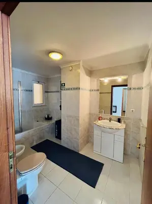 a bathroom with a toilet and a sink and a shower at Central Park Sea Views in Santa Cruz