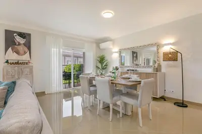 a living room with a table and a dining room at Casa Makin at Boa Vista Golf Resort, Bayview Village in Lagos