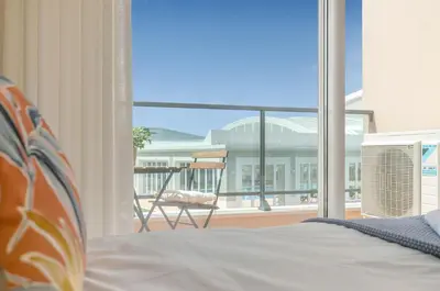 a bedroom with a bed and a view of a balcony at Casa Makin at Boa Vista Golf Resort, Bayview Village in Lagos