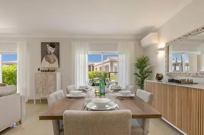 a dining room with a table and chairs at Casa Makin at Boa Vista Golf Resort, Bayview Village in Lagos