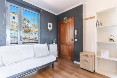 a bedroom with a bed and a wooden door at Vista Mar by Atlantic Holiday in Caniço