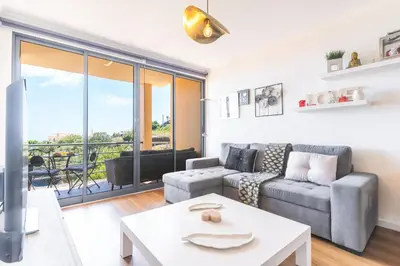 a living room with a couch and a table at Vista Mar by Atlantic Holiday in Caniço