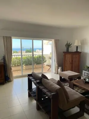 a living room with a couch and a view of the ocean at Appartement Praia da Luz - 2 Personnes - Vue mer in Luz