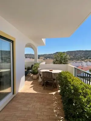 a patio with a table and chairs on a balcony at Appartement Praia da Luz - 2 Personnes - Vue mer in Luz