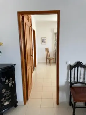 a hallway with a door open to a room with chairs at Appartement Praia da Luz - 2 Personnes - Vue mer in Luz