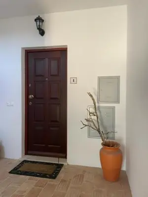 an orange vase sitting in front of a door at Appartement Praia da Luz - 2 Personnes - Vue mer in Luz