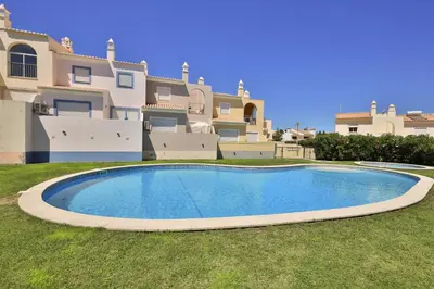 a large swimming pool in front of a large house at IM On Casa Mar e SOL in Lagos