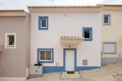 a white and blue building with a door at IM On Casa Mar e SOL in Lagos