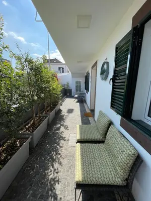 a patio with a couch and some plants at Casa de Sao Tiago 1 in Funchal