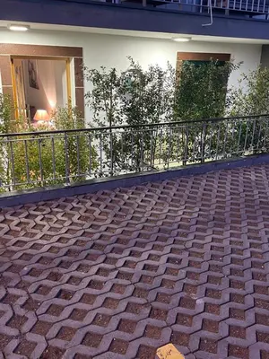 a balcony with a brick floor and a railing at Casa de Sao Tiago 1 in Funchal