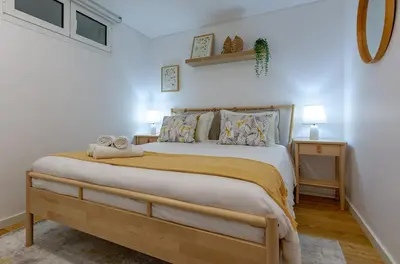 a bedroom with a large bed with two night stands at Casa de Sao Tiago 1 in Funchal