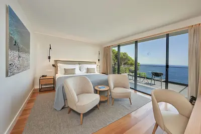 a bedroom with a bed and a view of the ocean at La Villa at The Cliff Bay - PortoBay in Funchal