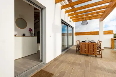 a kitchen and dining room with a table and chairs at Casa Monte Salema in Vila do Bispo