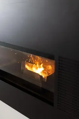 a fire in a fireplace with flames in it at Casa Monte Salema in Vila do Bispo