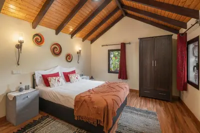 a bedroom with a large bed and a wooden ceiling at Casa de Campo Arco de São Jorge by An Island Apart in Santana
